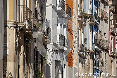 Facades of multi colored houses in a row on street of Alicante, spain Stock Photo