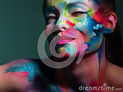 Face art and creative makeup, a young beautiful woman abstract art on the face Stock Photo