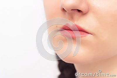 Face of a beautiful girl on a white background and red lips, the concept of lip augmentation in plastic surgery and aesthetic Stock Photo
