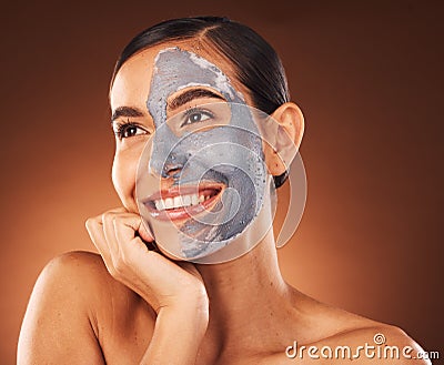 Face, beauty skincare and woman with clay mask in studio isolated on a brown background. Makeup, aesthetics and happy Stock Photo