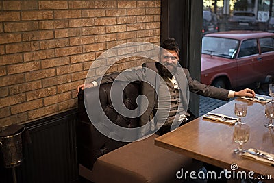 Face boy for magazine cover. Man face portrait in your advertisnent. Bearded man rest in restaurant at table. Date Stock Photo