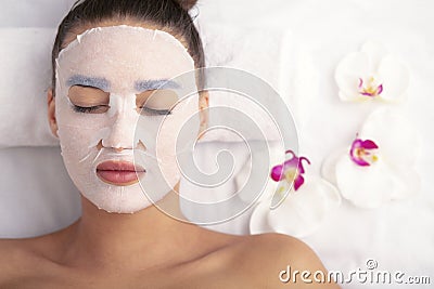 Woman with cotton face mask in beauty salon Stock Photo