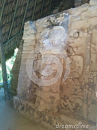 Face carved in stone in Mayan ruins Stock Photo