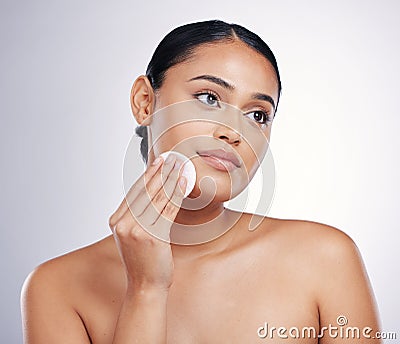 Face, cleaning and cotton on skin of a woman in studio for natural beauty, dermatology or cosmetics. Female person with Stock Photo