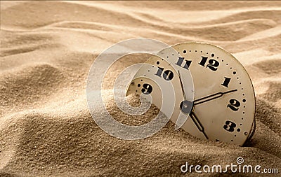 Face of clock in sand Stock Photo