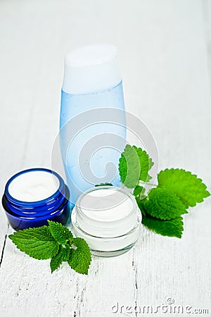 Face cream and lotion with urtica leaves Stock Photo