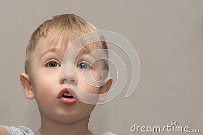 The face of a cute blond boy 3 years old close-up with facial expressions and emotions of an indignant child Stock Photo