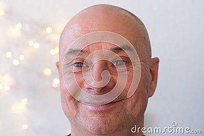 Face of an elderly bald man close-up, senor looks, smiles, thinks, dreams of a good, concept spring, good mood Stock Photo