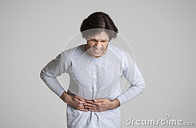 Face expresses torment acute pain in stomach Stock Photo
