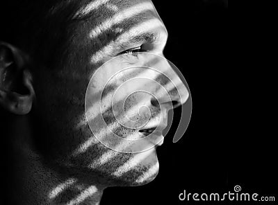 Face Of Handsome Man With Strips Of Light And Shadows On Her Face. Stock Photo