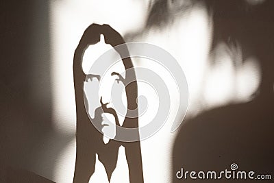 Face of jesus Christ shadow on the wall portrait Stock Photo