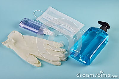 Face mask with hand sanitizer bottle, liquid soap dispenser and latex gloves Stock Photo