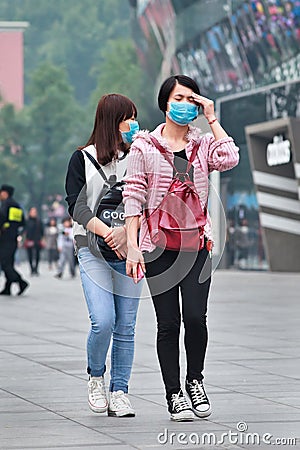 Face masked girl gets dizzy from smog, Beijing, China Editorial Stock Photo