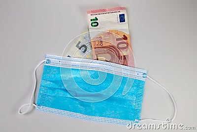 Corona crisis rise up the prize for Face masks. Euros with mask Stock Photo