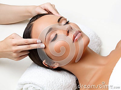 Face Massage. Close-up of a Young Woman Getting Spa Treatment. Stock Photo