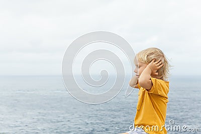 Face portrait of annoyed, unhappy caucasian child grabbed head Stock Photo