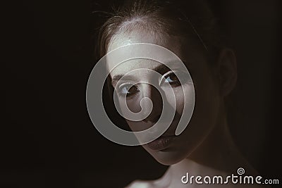 Face of pretty woman with make up in darkness. Mysterious girl hiding from day light. Portrait calm face mysterious Stock Photo