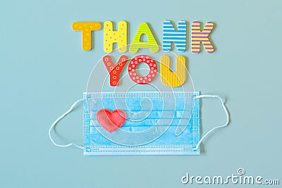 Face protective mask with heart and words THANK YOU of wooden letters Stock Photo