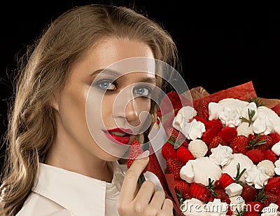 Face, red lips, strawberry, marshmallows, black background Stock Photo