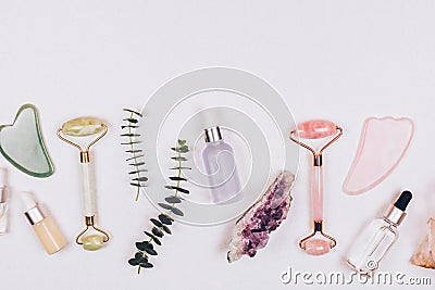 Face rollers, massager guasha scraper, eucalyptus and natural stones. Stock Photo