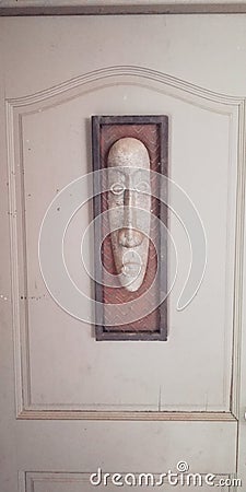 Face sculpture on wooden door Editorial Stock Photo