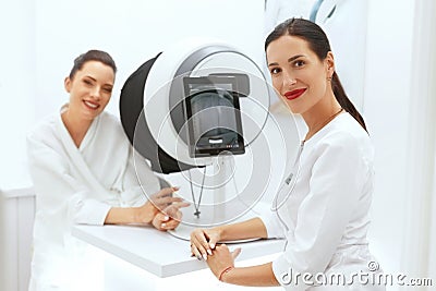 Face Skin Analyze. Cosmetologist Analyzing Woman Facial Skin Stock Photo