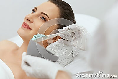 Face Skin Care. Woman Doing Alginate Facial Mask At Cosmetology Stock Photo