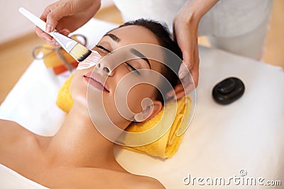 Face Treatment. Woman in Beauty Salon Gets Marine Mask Stock Photo