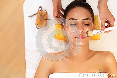 Face Treatment. Woman in Beauty Salon Gets Marine Mask Stock Photo