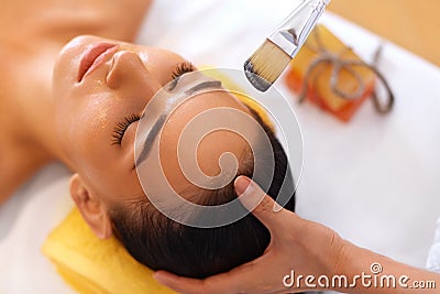 Face Treatment. Woman in Beauty Salon Gets Marine Mask Stock Photo