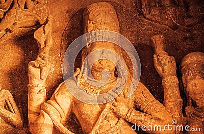 Face of Vishnu Lord in sculpture with many details on wall of old relief. Ancient Indian architecture in Badami, India Stock Photo