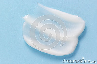 Face wash texture. White pore cleansing foam gel smear smudge on pastel blue background Stock Photo