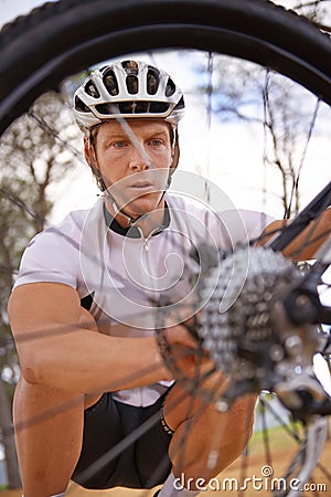 Face, wheel and repair with man cycling outdoor in nature for exercise, fitness or sports training. Bike, accident and Stock Photo