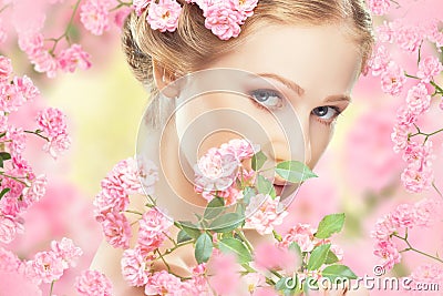 Face of young beautiful woman with pink flowers Stock Photo