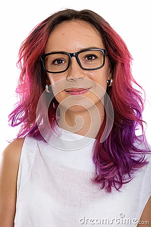 Face of young beautiful woman with pink hair and wearing eyeglas Stock Photo