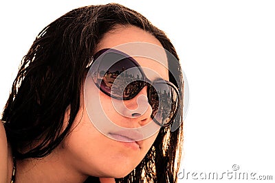 Face of young brunette girl in sunglasses with beach reflection in bright sun rays Stock Photo