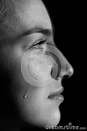 Face of young woman with tear drop close up Stock Photo