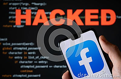 Facebook app logo seen on the smartphone and blurred HACKED word with a brute force script on the blurred background. Concept for Editorial Stock Photo