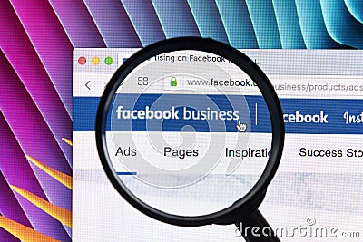 Facebook business homepage website on Apple iMac monitor screen under magnifying glass. Facebook is the most popular social Editorial Stock Photo