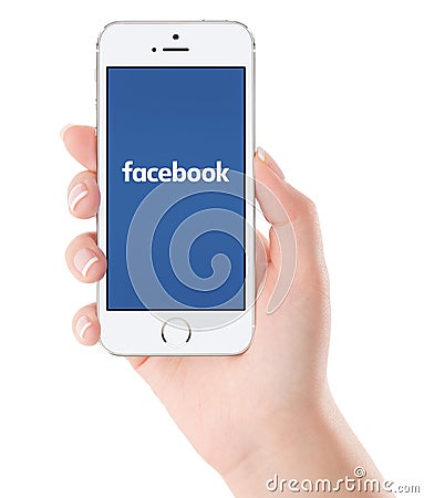 Facebook logo on white Apple iPhone 5s display in female hand Editorial Stock Photo