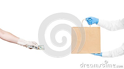 Faceless delivery man hold in hands brown craft paper package and hand holds give money to pay. Stock Photo