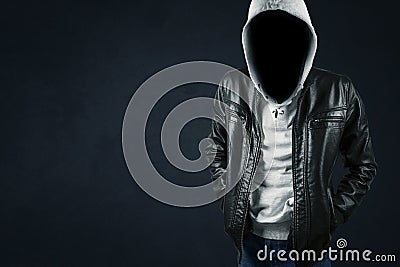 Faceless hacker in dark background Stock Photo