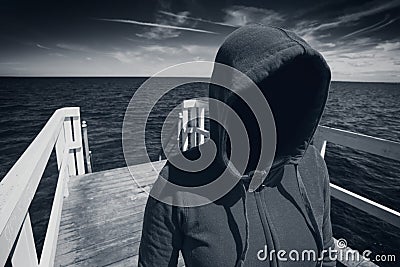 Faceless Hooded Unrecognizable Woman at Ocean Pier, Abduction Co Stock Photo