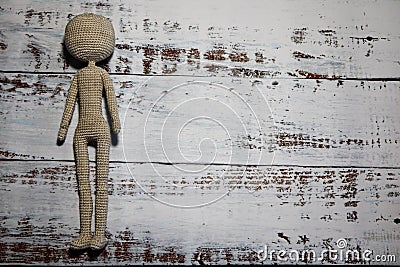 Faceless knitted human figure on wooden background Stock Photo