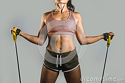 Faceless portrait of young fit and athletic sport woman working hard with elastic resistance bands in fitness workout training iso Stock Photo