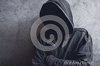 Faceless unrecognizable man with hood Stock Photo