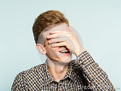 Facepalm happy smiling joyful man cover face shame Stock Photo