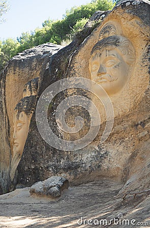 Faces carved in stone on the Route of Faces Stock Photo