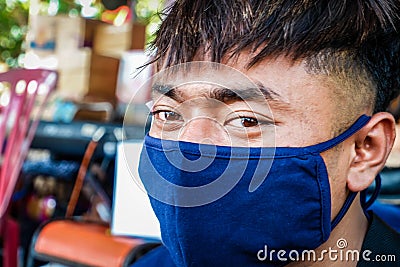 faces of Indonesian youths wearing masks to prevent the spread of covid-19 Editorial Stock Photo