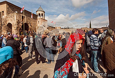 Faces of people coming to the historical christian Svetitskhoveli Cathedral. UNESCO World Heritage Site. Editorial Stock Photo